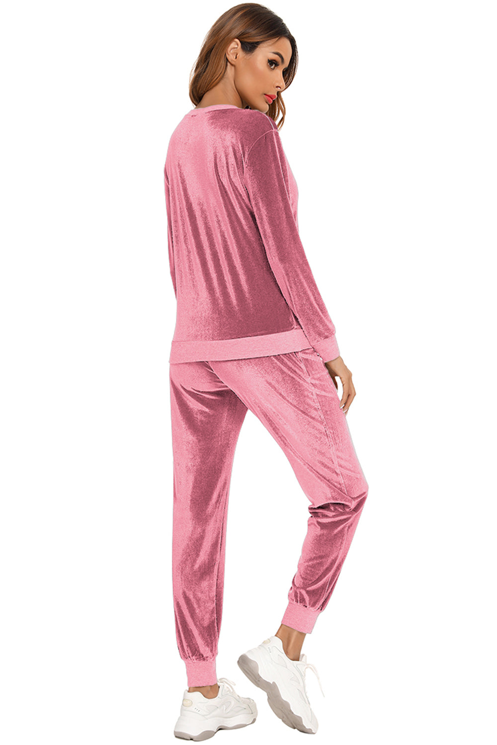 Woman wearing a dusty pink round neck long sleeve loungewear set with matching pants, back view