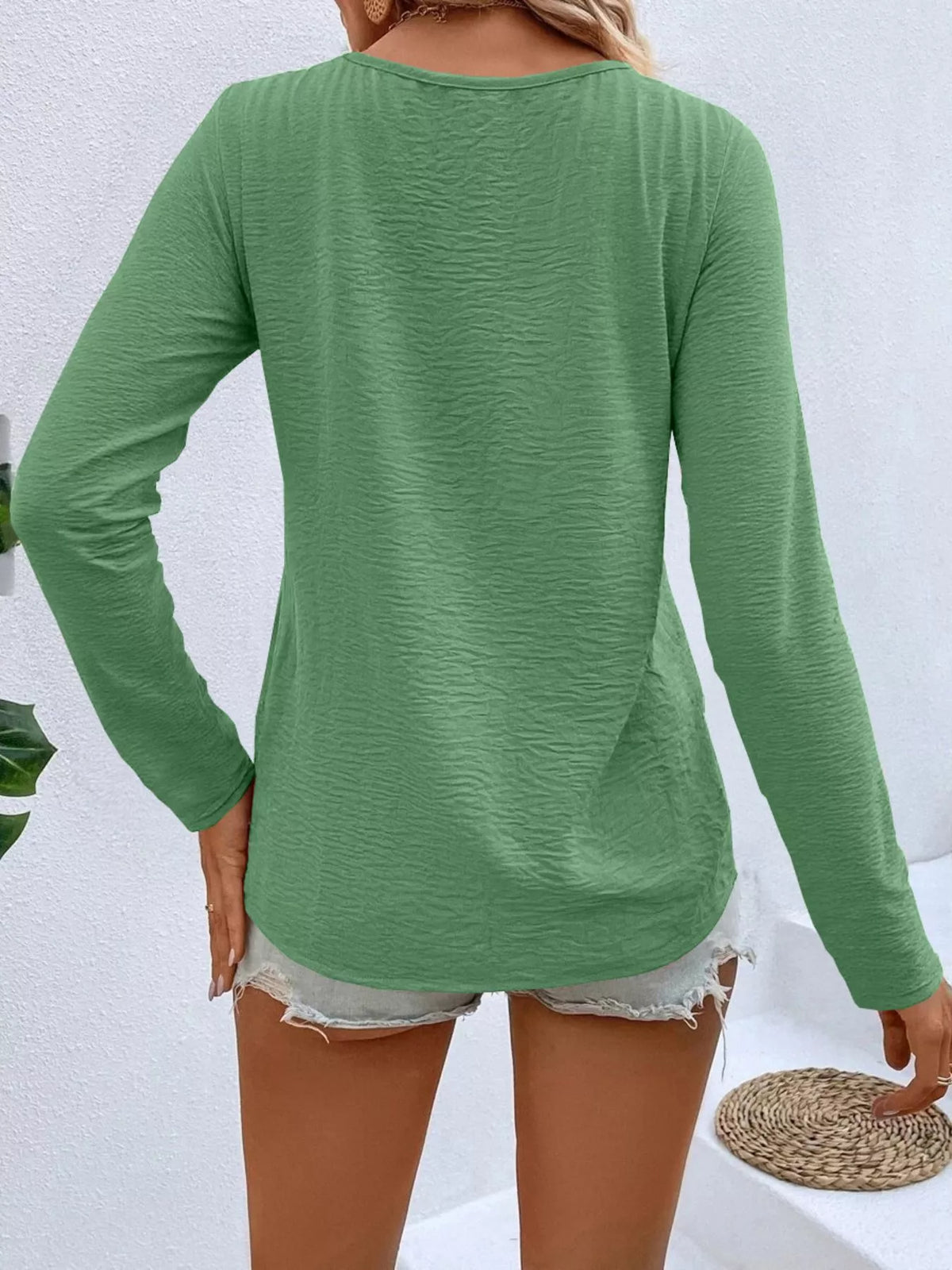 Back view of women's grass green long sleeve V-neck top