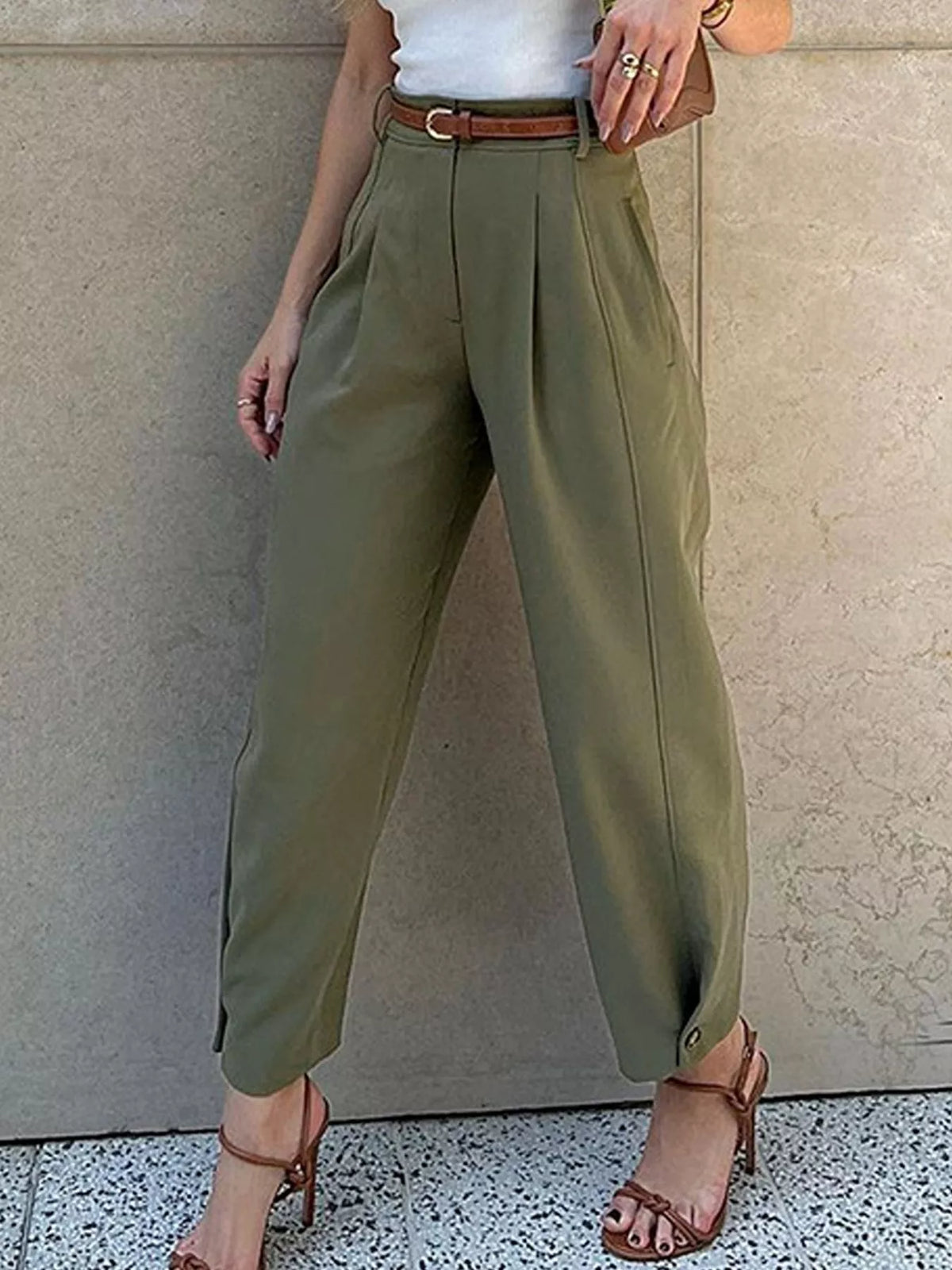 Woman wearing army green high-waisted pleated straight-leg pants