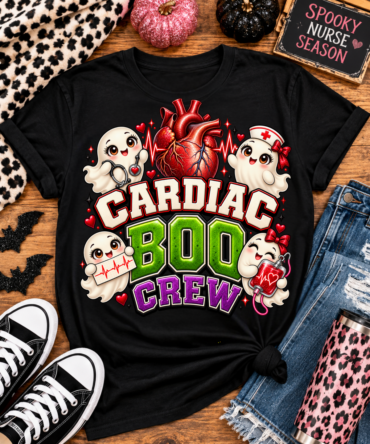 Black Cardiac Boo Crew Halloween cardiology nurse graphic tee styled flat with pink pumpkins, leopard print accessories, denim jeans and sneakers.