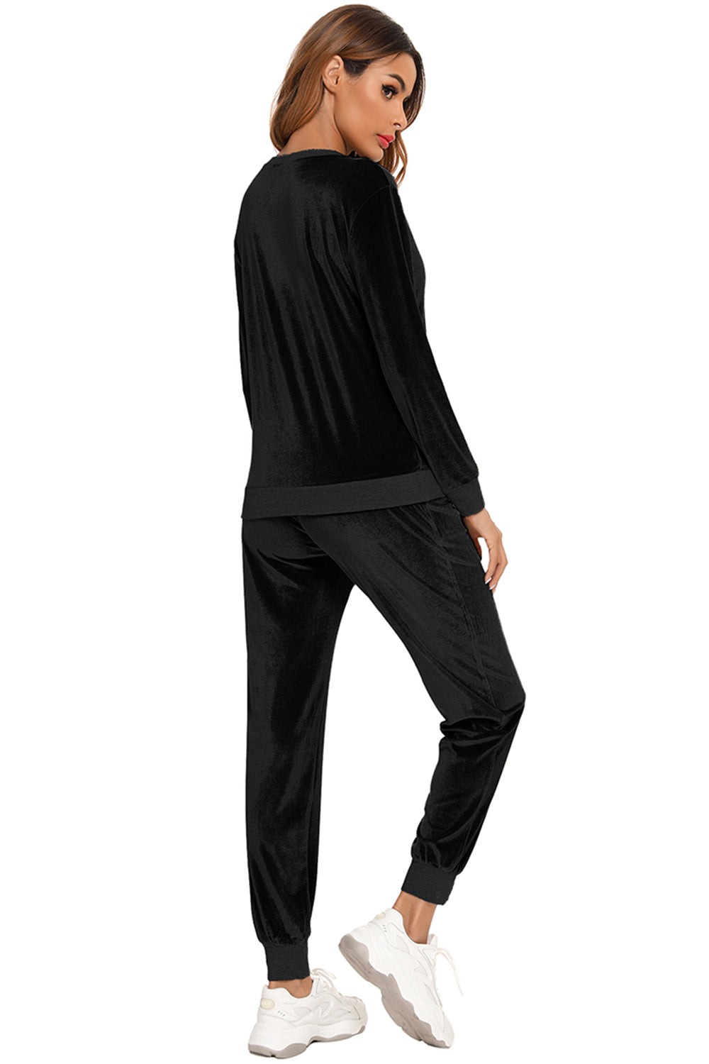 Woman wearing a black round neck long sleeve loungewear set with matching pants, back view