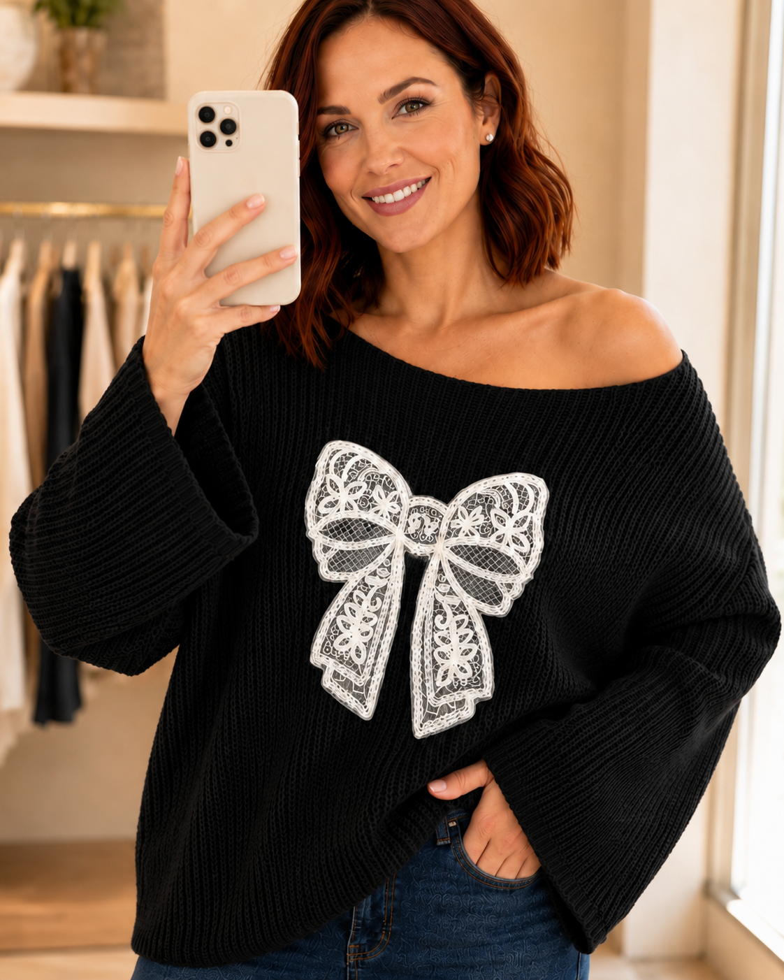 Close-up of a woman wearing a black open-knit sweater with a white lace bow and bell sleeves