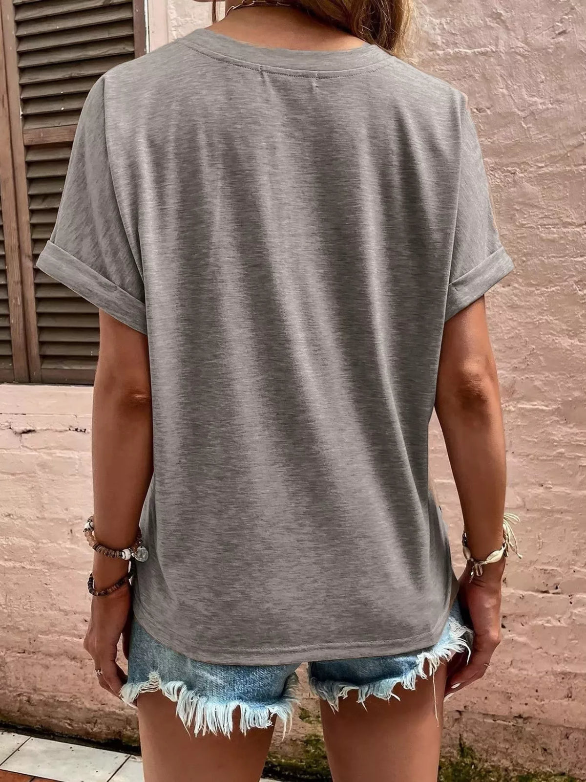 Women's gray blouse showing rolled sleeve and back detail