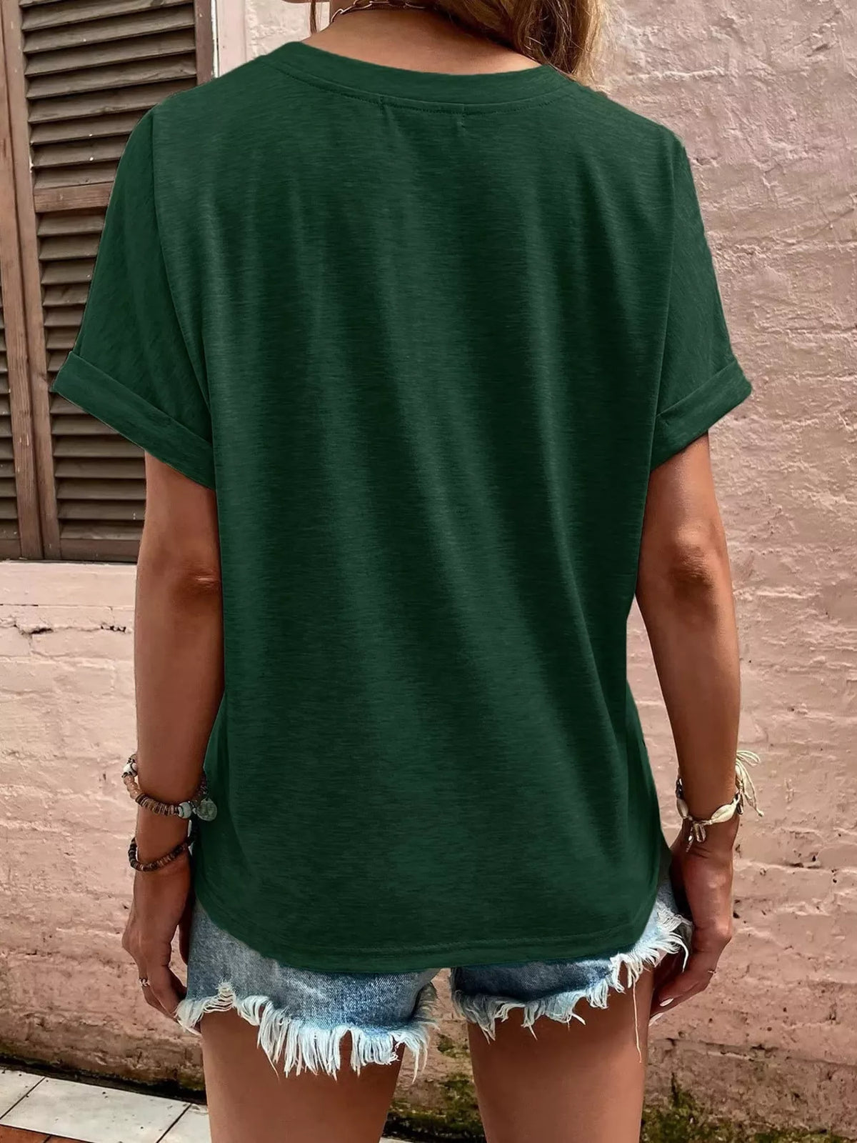 Women's green blouse showing rolled sleeve and back detail