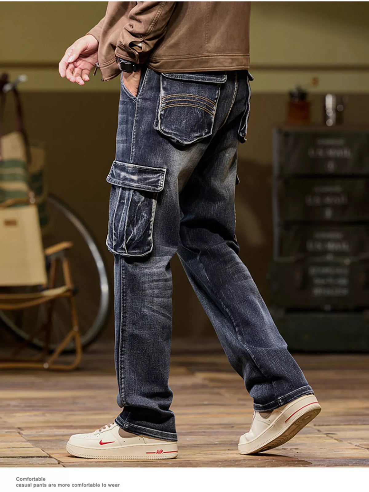 Men's black vintage wash loose fit cargo jeans with utility pockets, rear side view