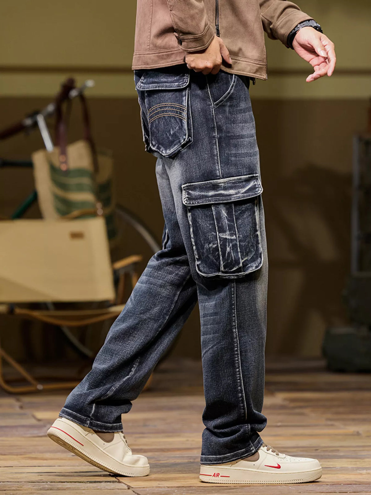 Men's black vintage wash loose fit cargo jeans with utility pockets, side view