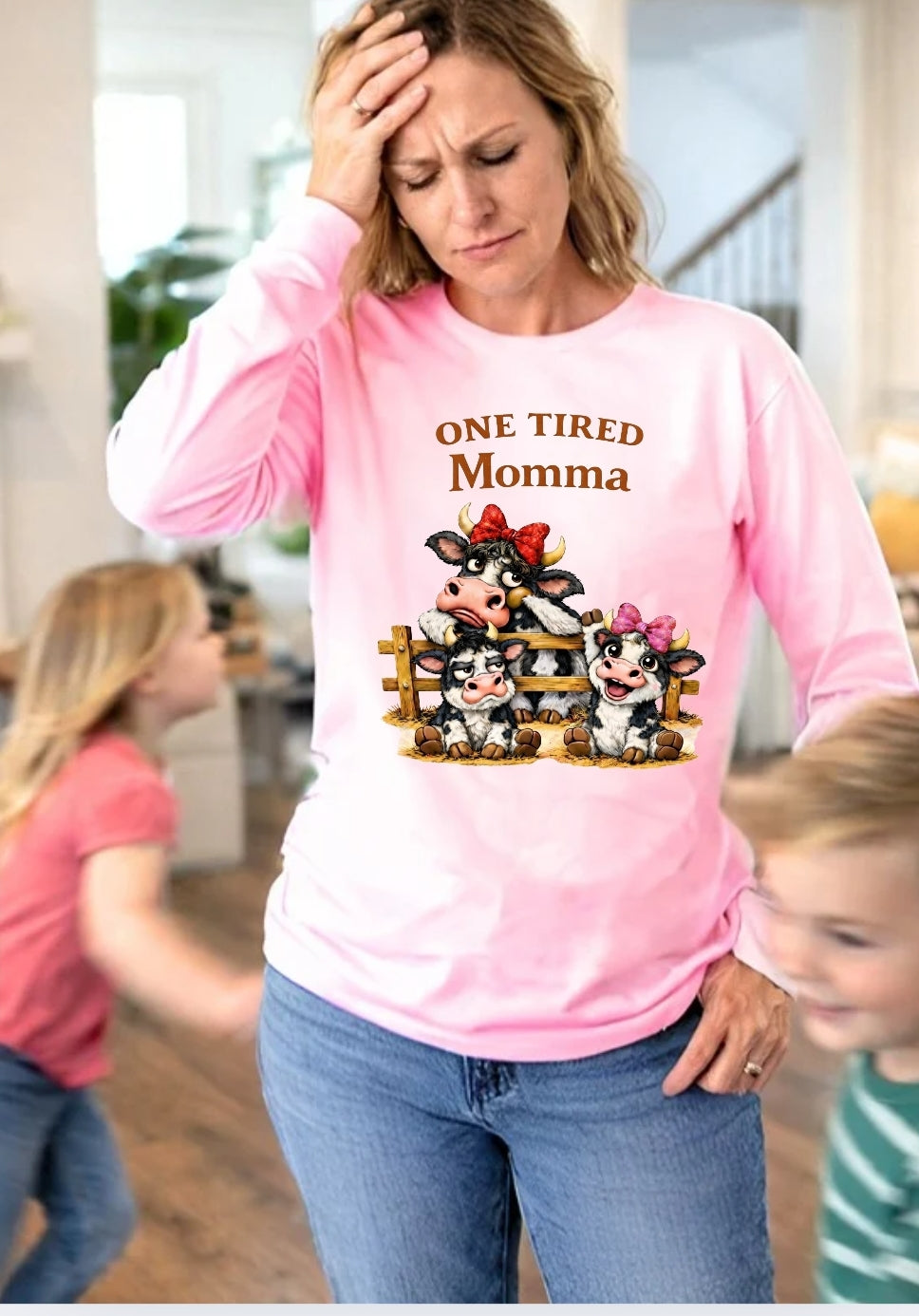 Woman wearing a pink long sleeve shirt with One Tired Momma cow graphic in a home setting





    

Is this conversation helpful so far?