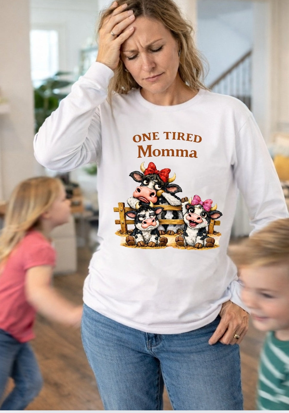 Woman wearing a white long sleeve shirt with One Tired Momma cow graphic in a home setting





    

Is this conversation helpful so far?