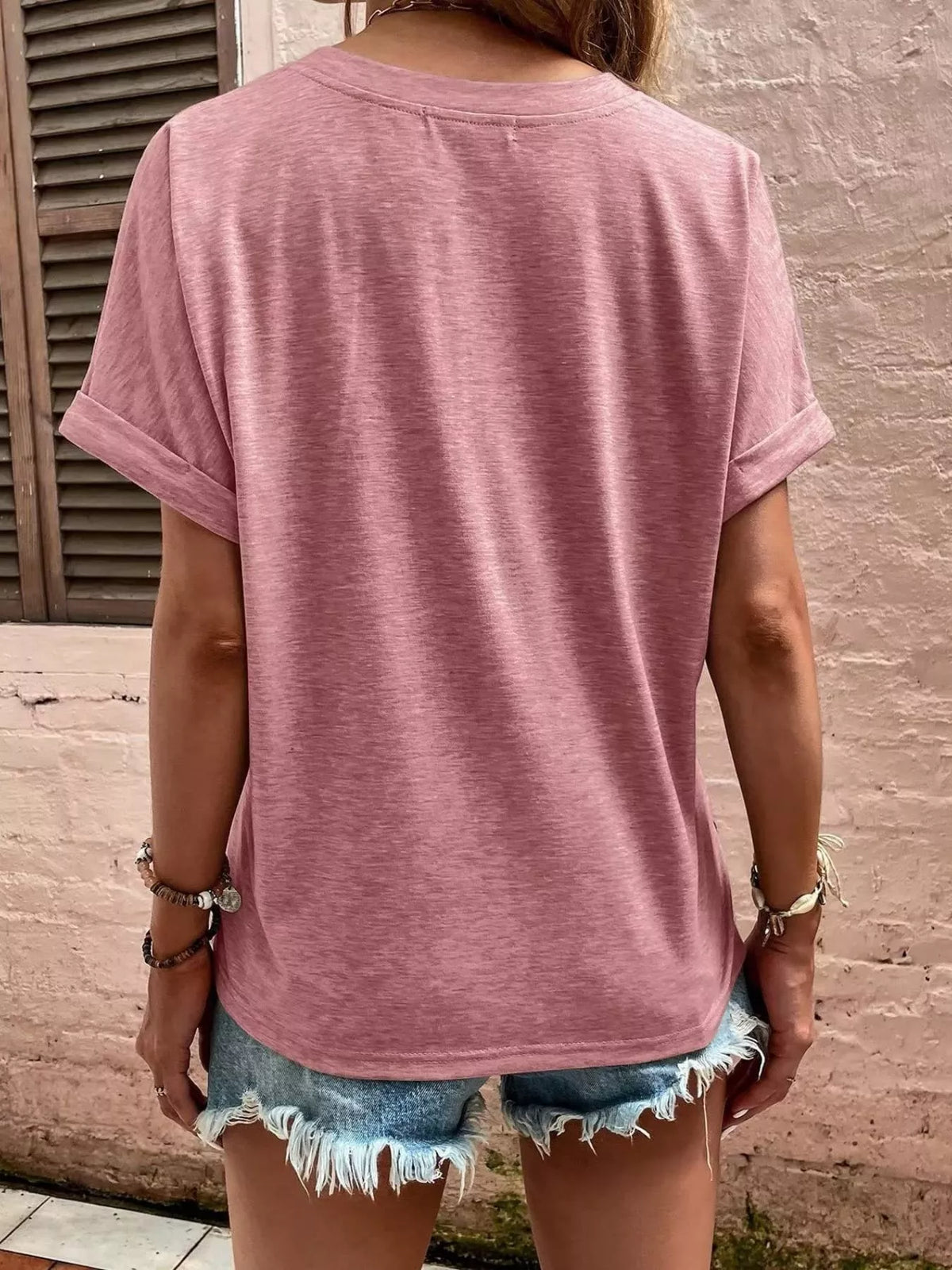 Women's pink blouse showing rolled sleeve and back detail