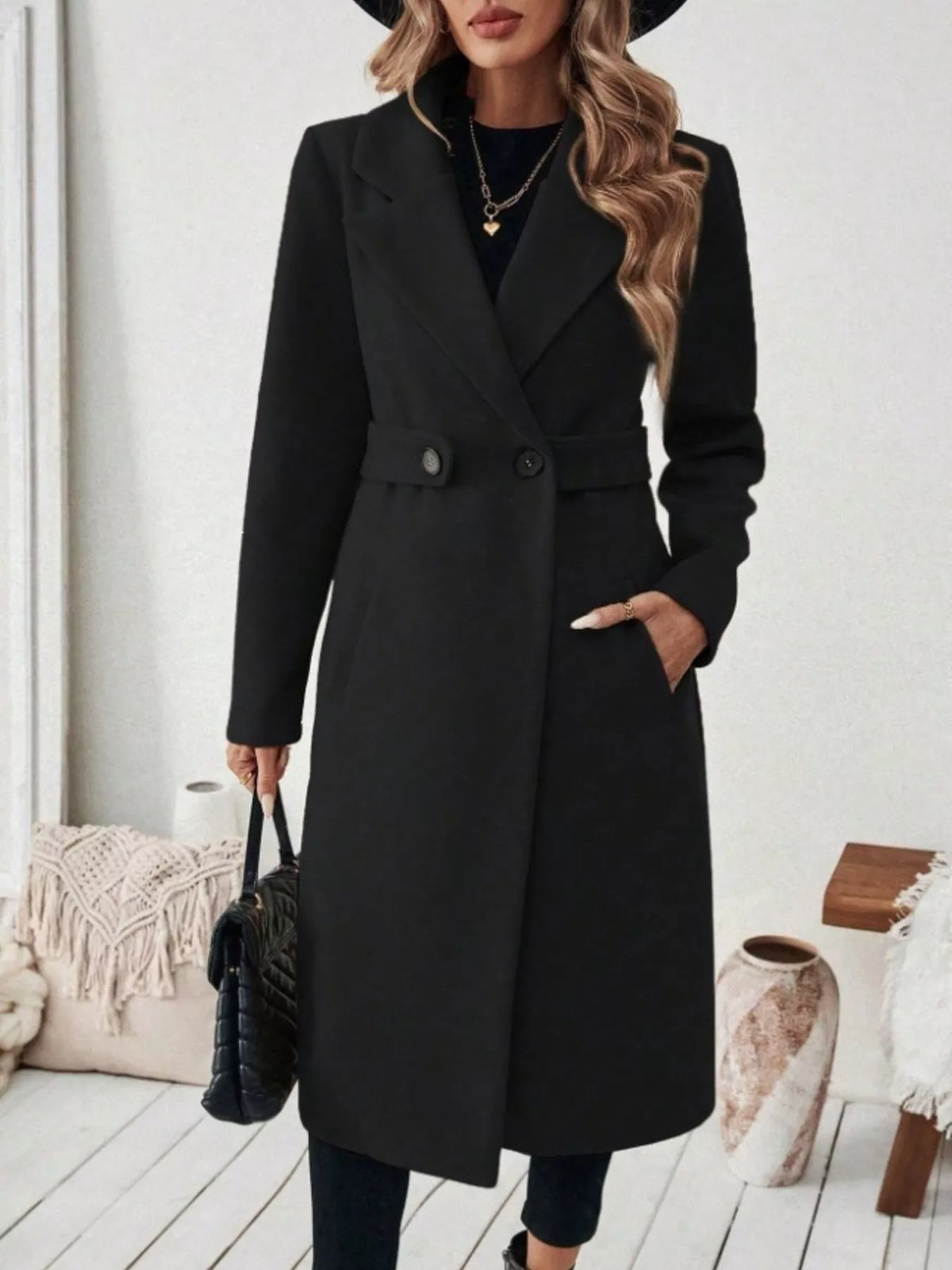 Woman wearing a black belted lapel collar coat with pockets