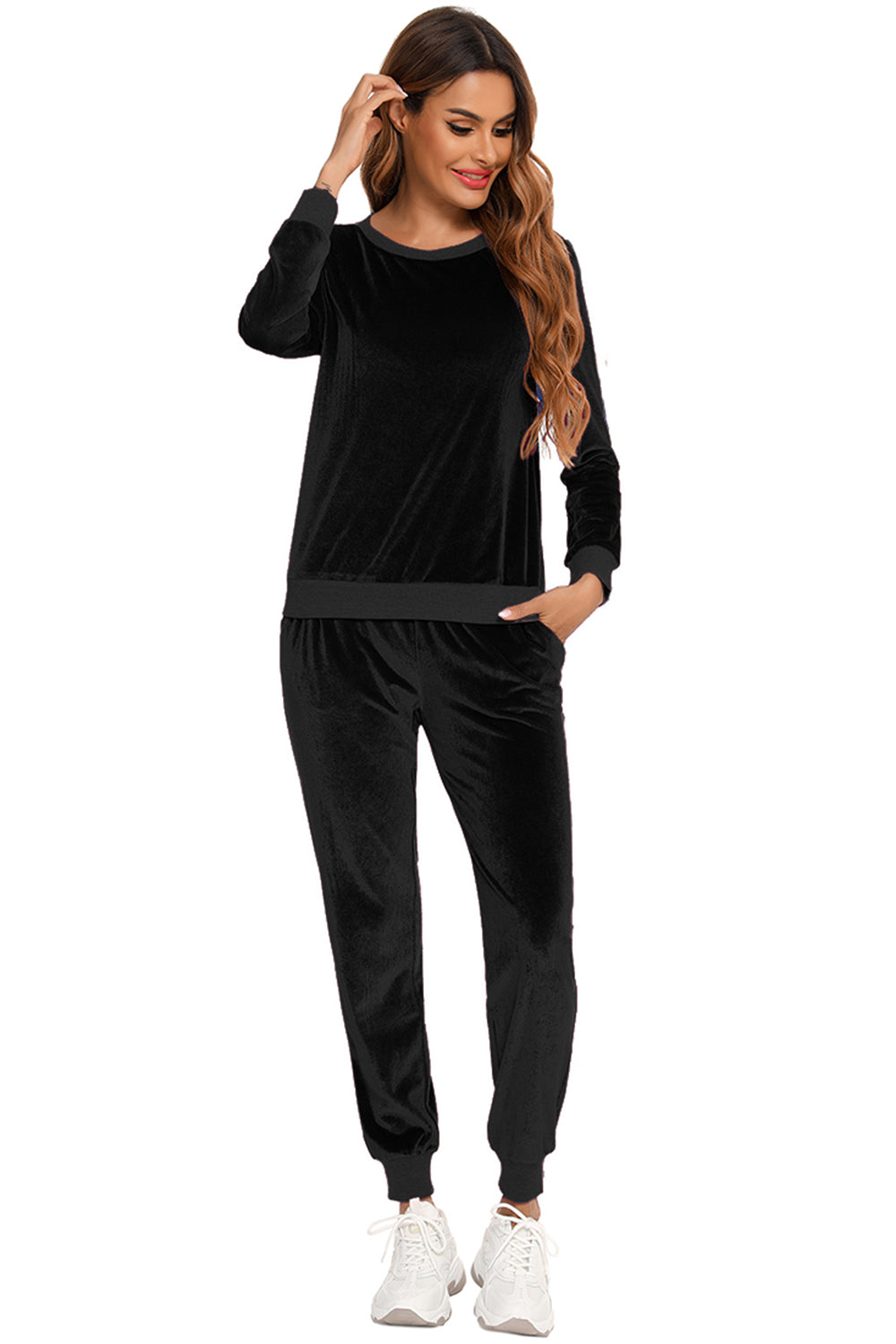 Woman wearing a black round neck long sleeve loungewear set with pocketed pants, front view