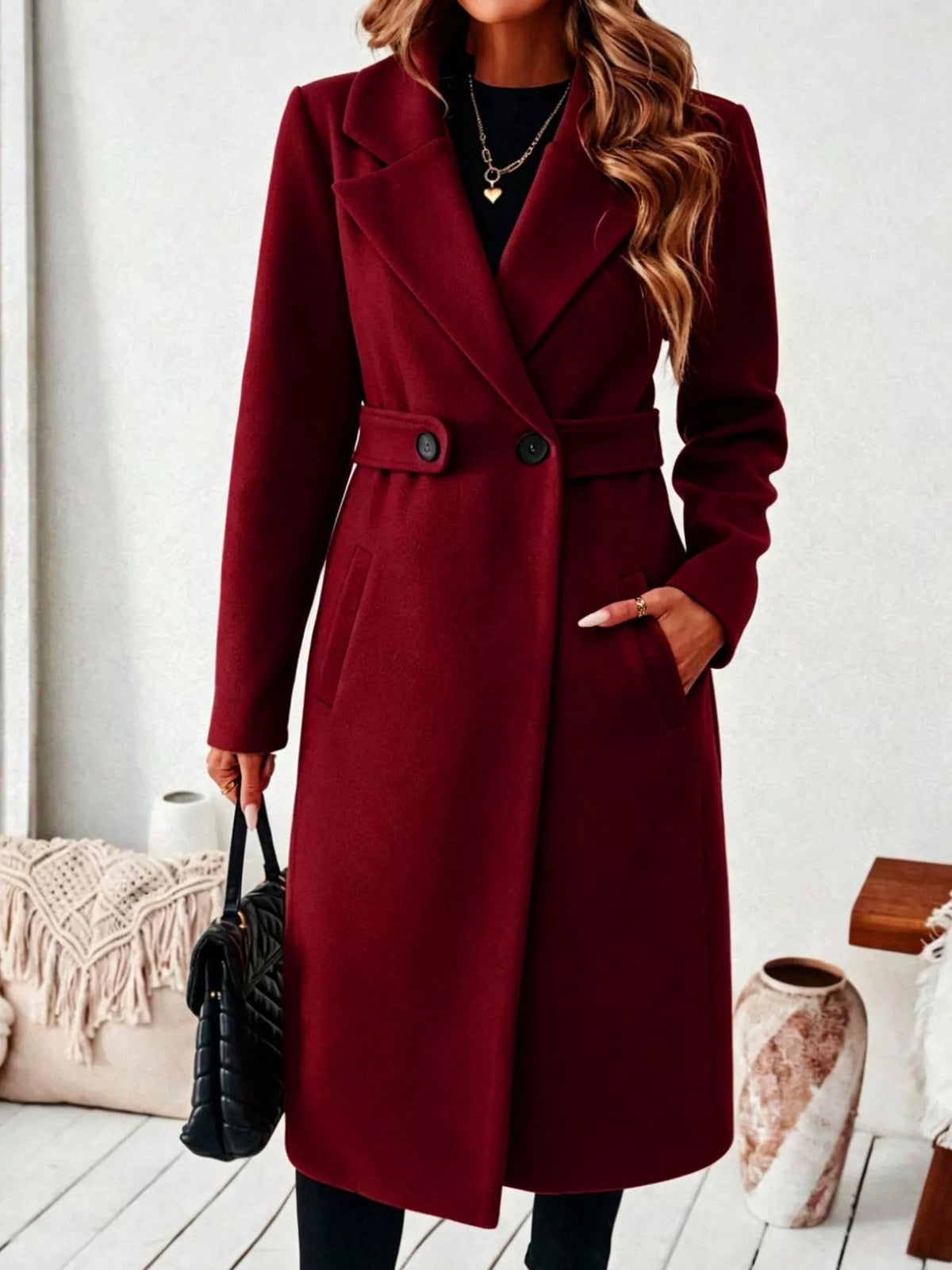 Woman wearing a burgundy belted lapel collar coat with pockets