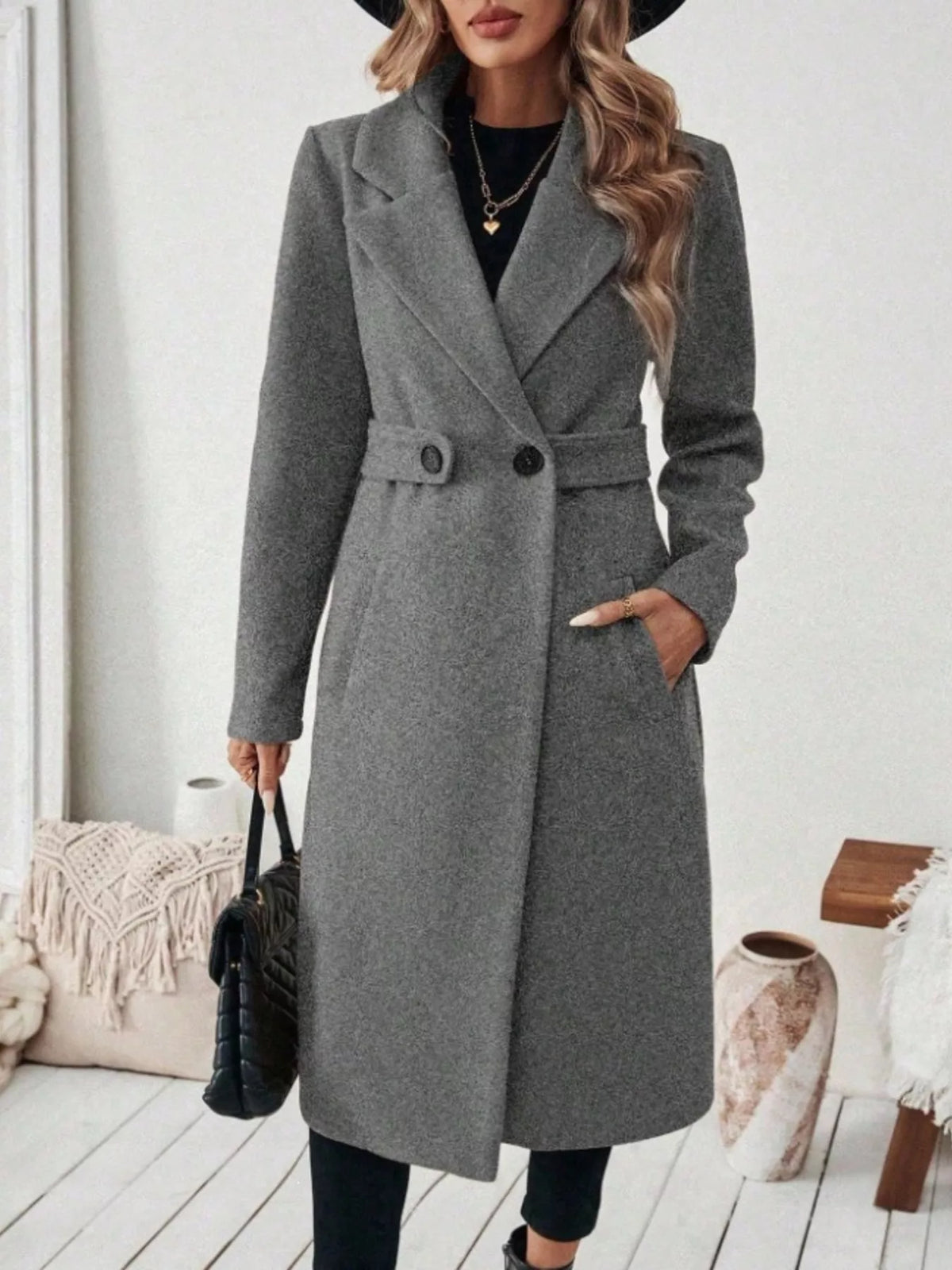 Woman wearing a gray belted lapel collar coat with pockets