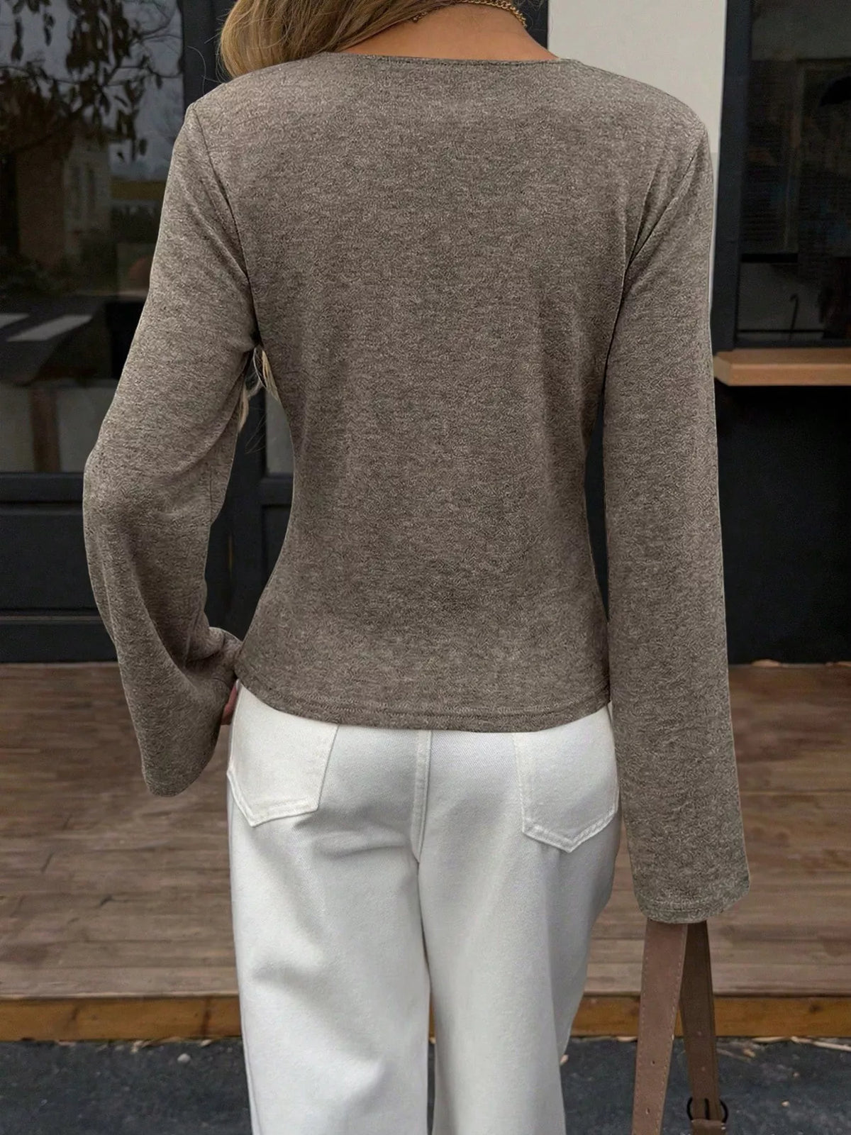 Back view of women's olive asymmetrical long sleeve blouse