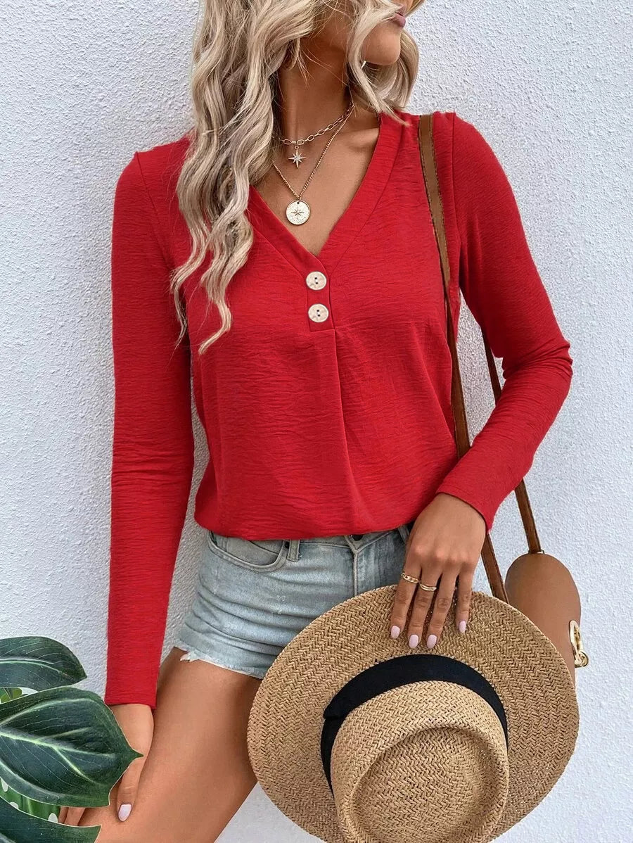 Woman wearing a red V-neck button detail long sleeve top