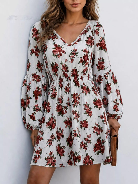 Woman wearing a white floral print V-neck long sleeve mini dress